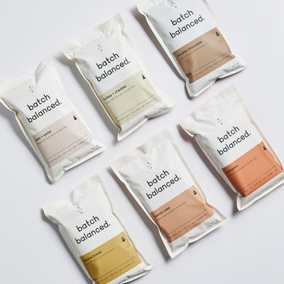Multiple packages of 'batch balanced' products on a light background