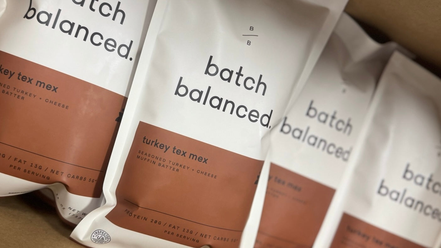 Packaged savory muffins labeled 'batch balanced' with a description of 'turkey tex mex' on the packaging.