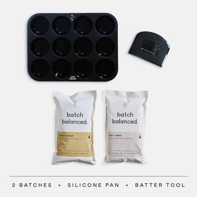 Baking set with silicone pan and batter tool on a white background